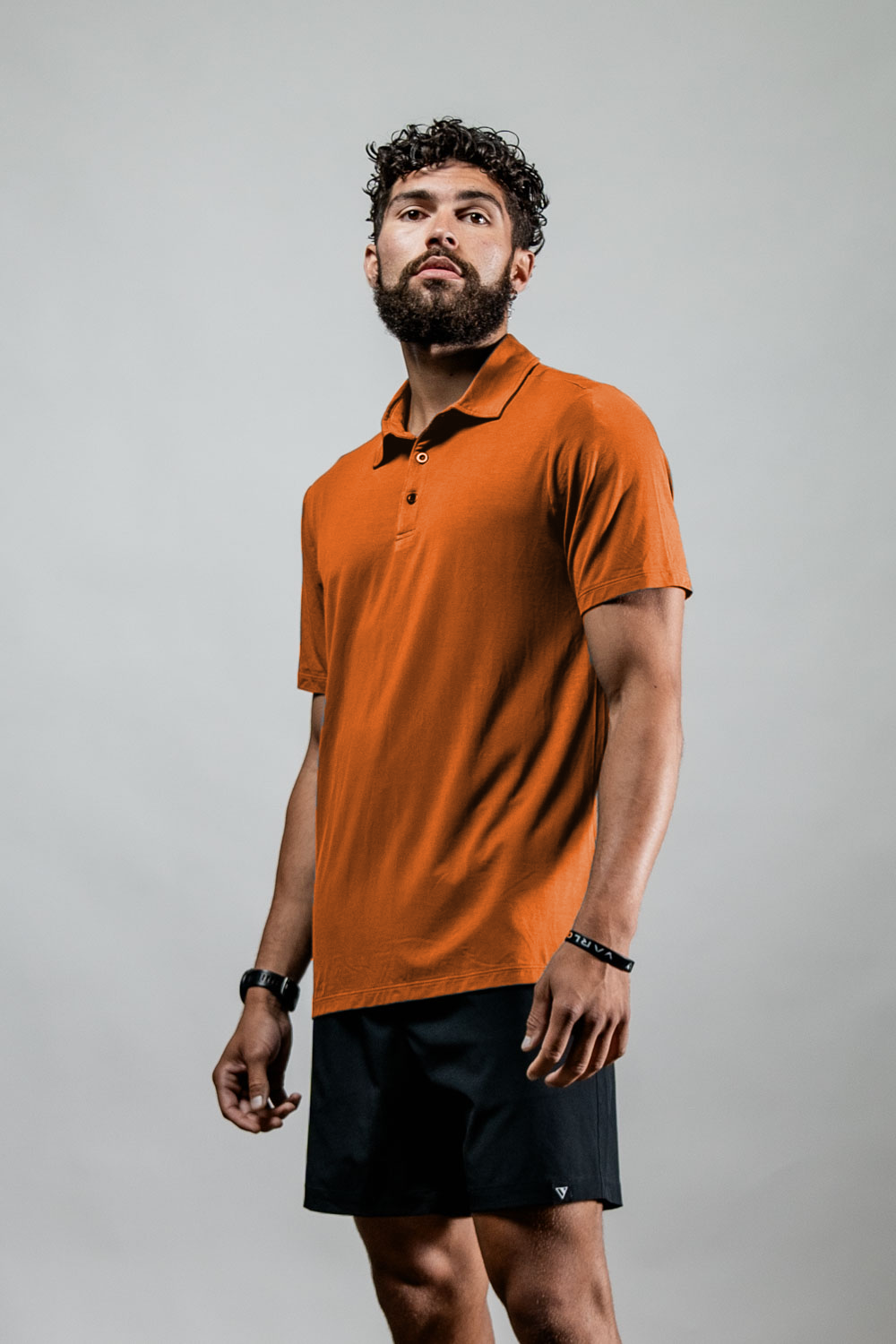 Varlo Men's Terra Recovery Polo (Sunfire Clay) — lifestyle worn / used context