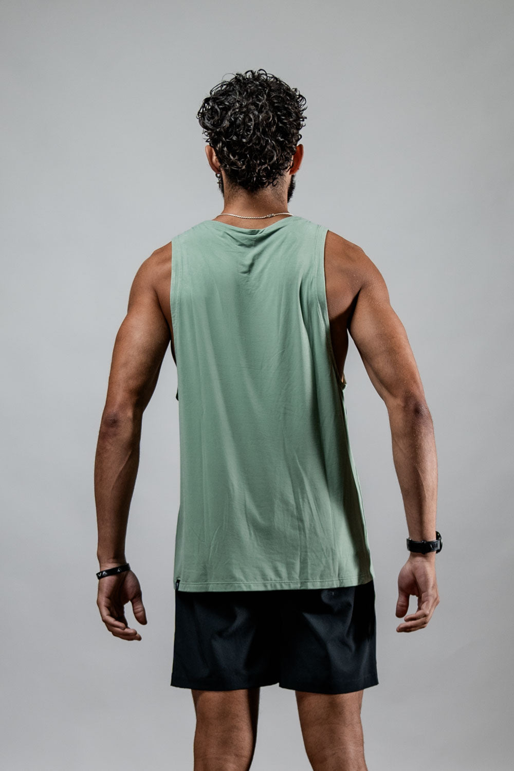Varlo Men's Terra Recovery Tank (Low Light Olive) — lifestyle worn / used context