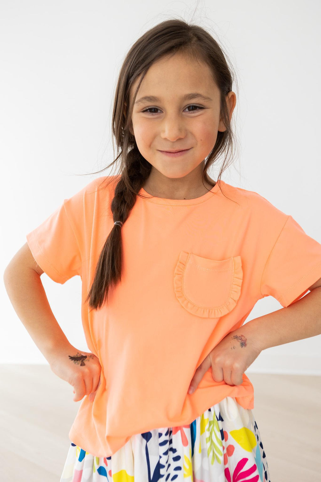 Mila & Rose ® Neon Coral Ruffle Pocket Tee — lifestyle context