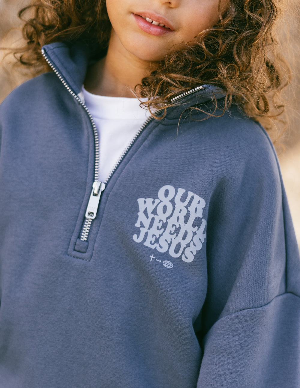 Elevated Faith Our World Needs Jesus Kids Half-Zip — main product shot
