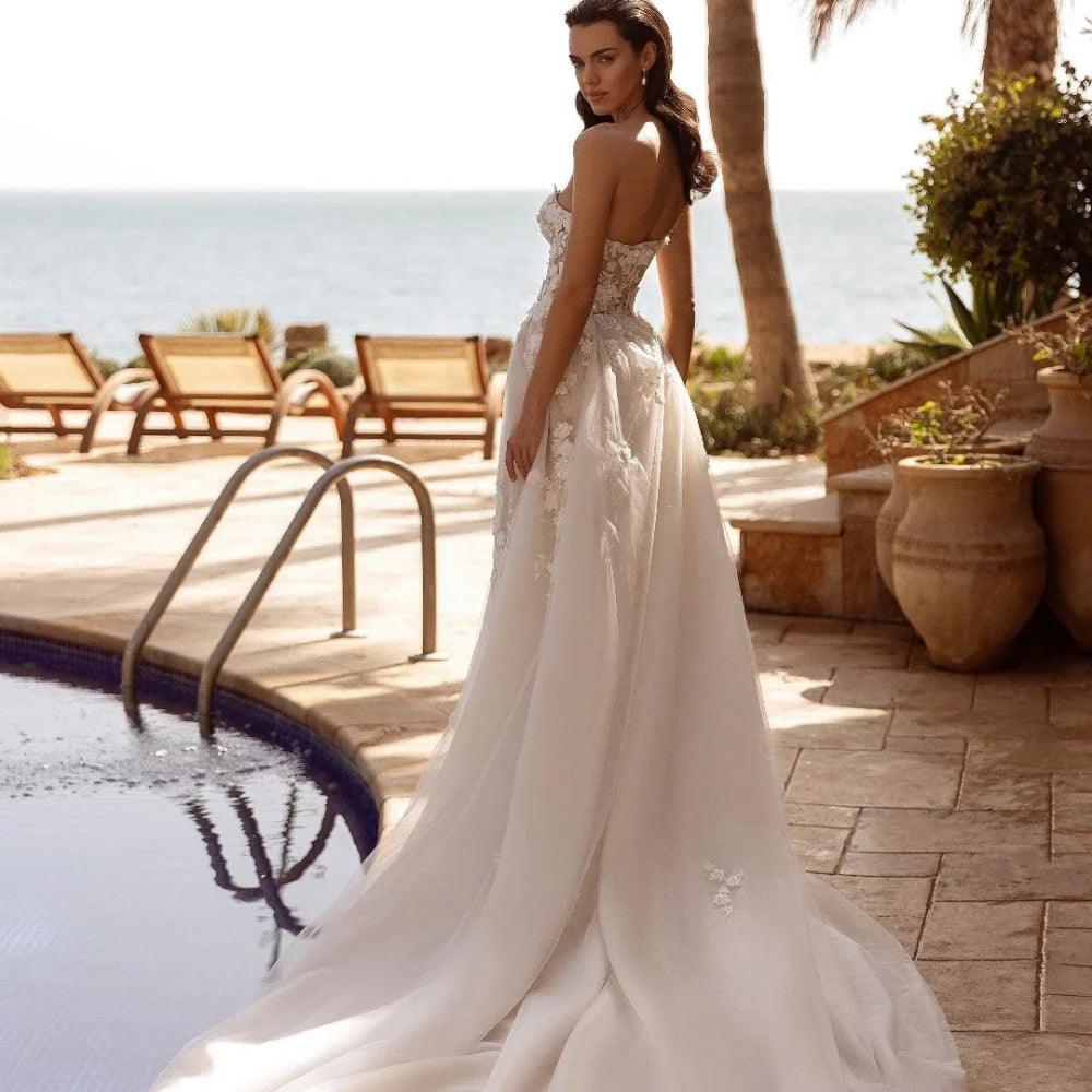 Envy NYC Envy NYC Detachable Train Mermaid Wedding Dress — Envy NYC branding close-up