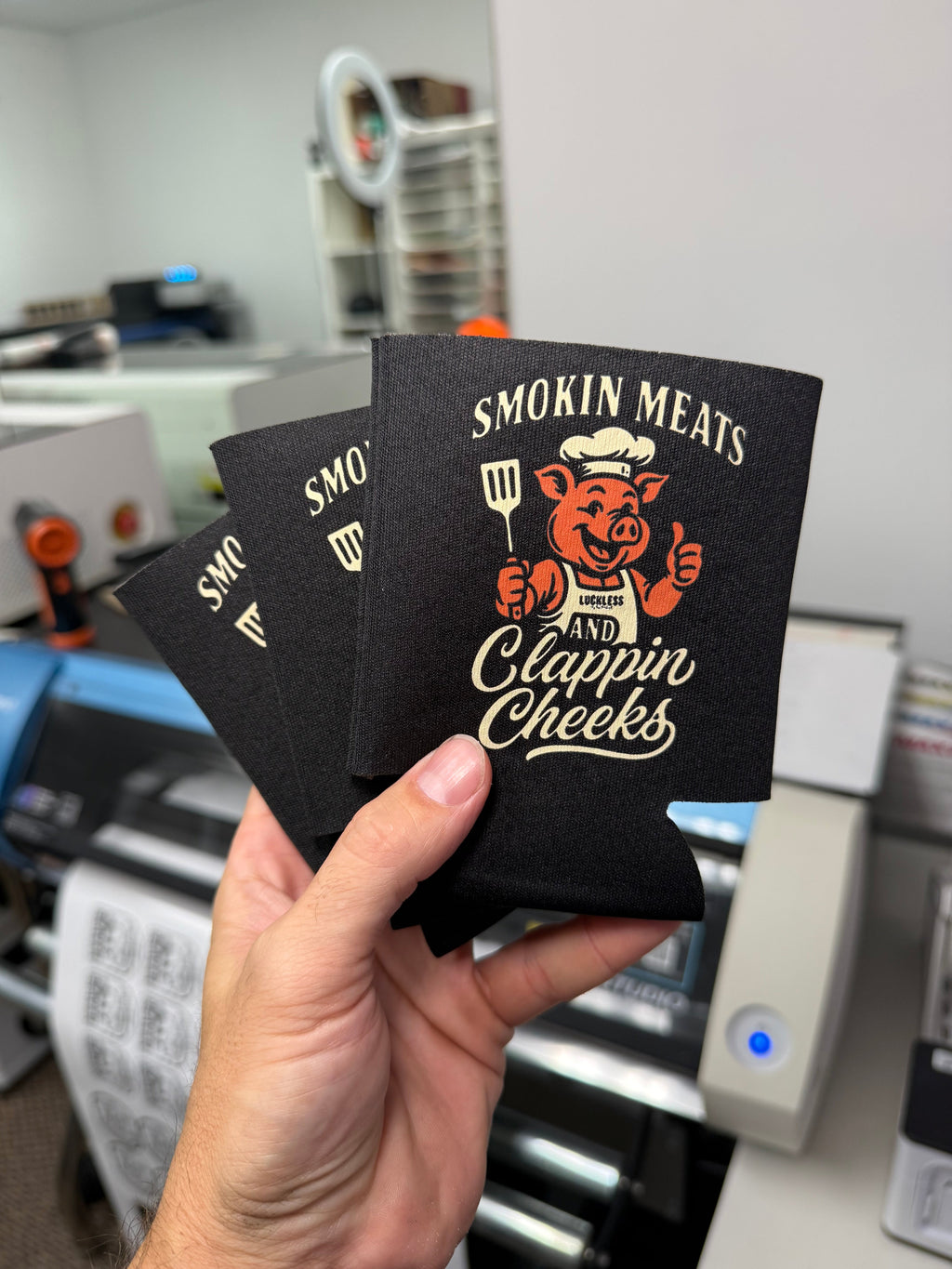 Luckless Outfitters Smokin Meats and Clappin Cheeks Koozie — lifestyle context