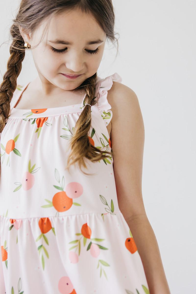 Mila & Rose ® Tangerine Ruffle Cross Back Dress — lifestyle context