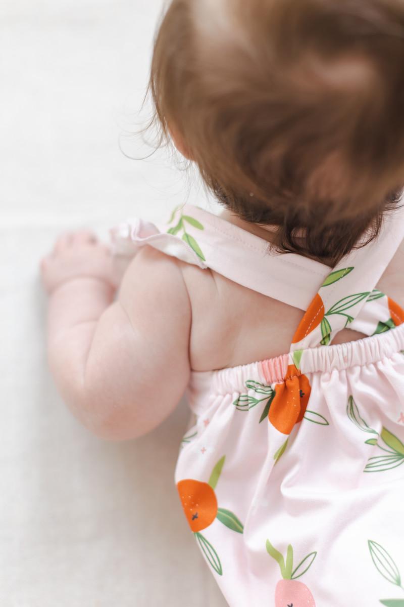 Mila & Rose ® Tangerine Ruffle Cross Back Romper — detail close-up