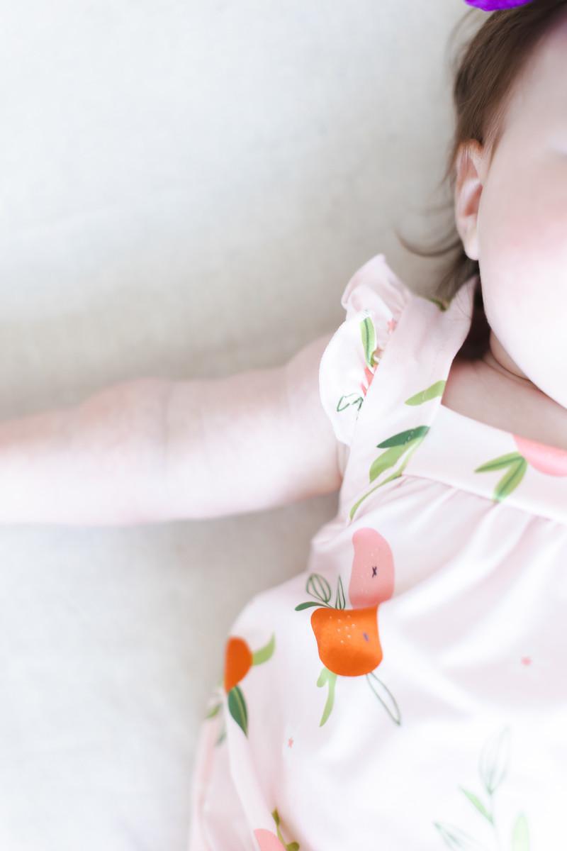 Mila & Rose ® Tangerine Ruffle Cross Back Romper — in-use photo