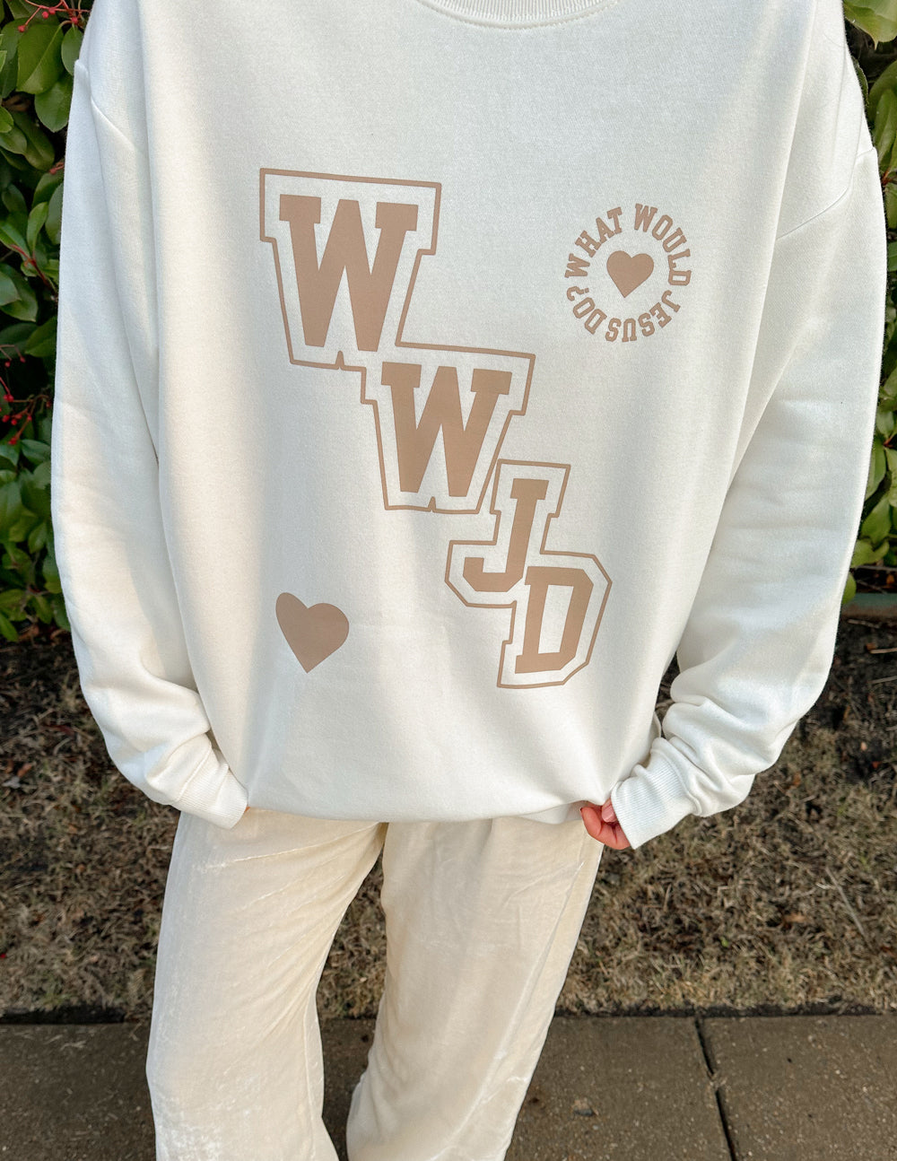 Elevated Faith WWJD Varsity Unisex Crewneck — Elevated Faith branding close-up