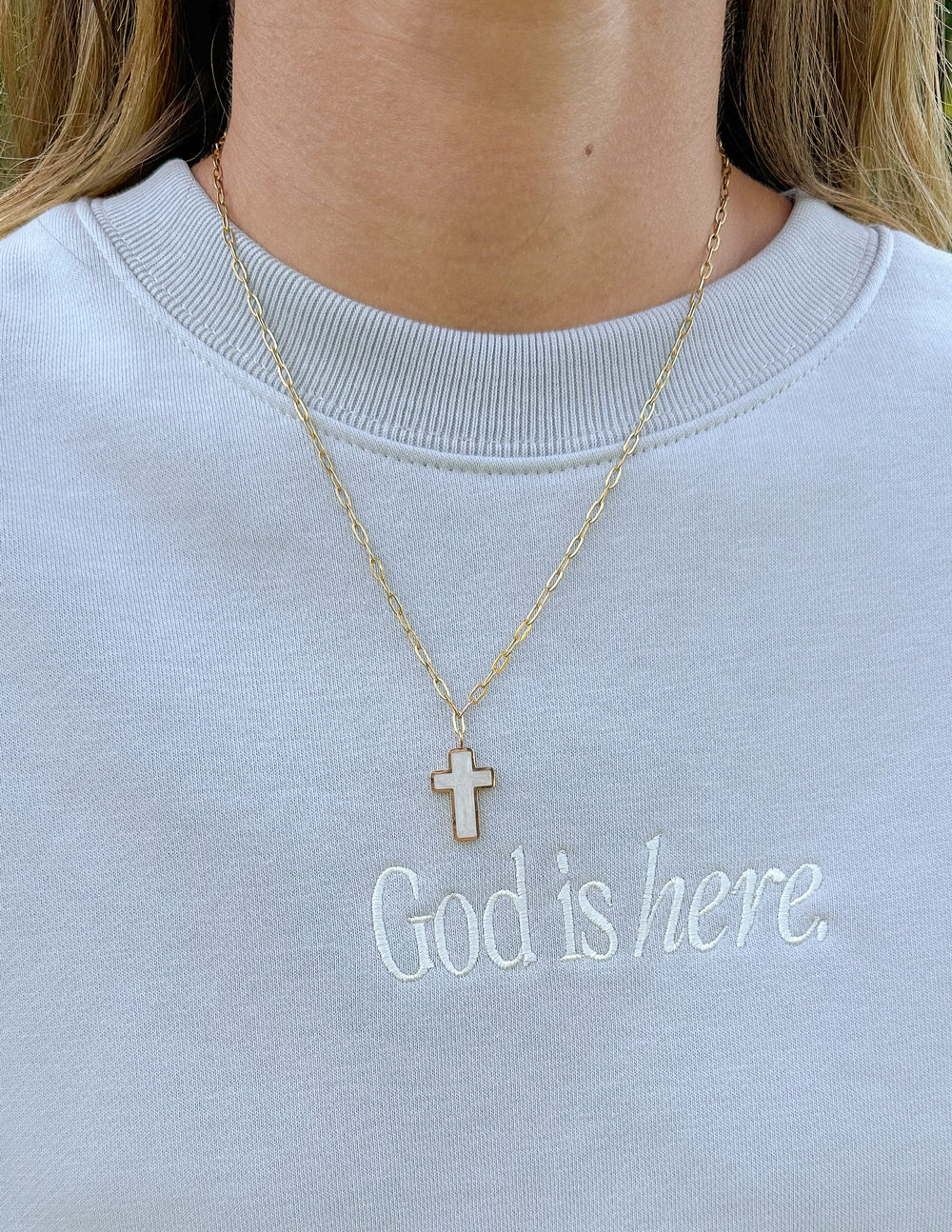 Elevated Faith White Enamel Cross Necklace — Elevated Faith branding close-up
