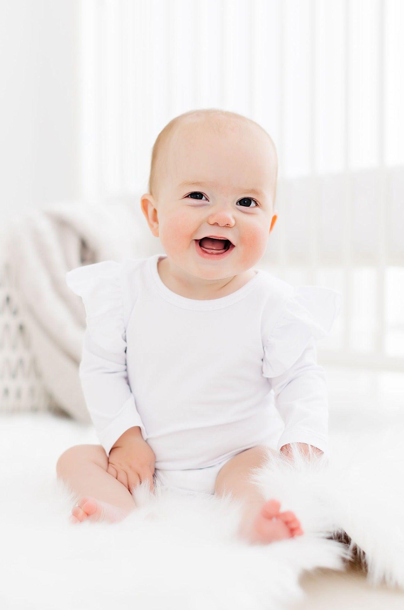 Mila & Rose ® White L/S Flutter Bodysuit — lifestyle context