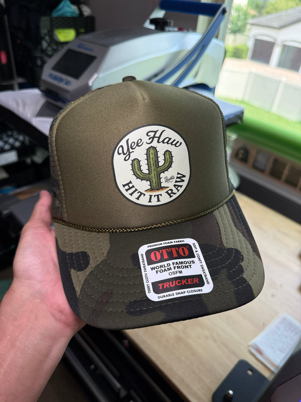 Luckless Outfitters Yee Haw Hit it Raw Camo Trucker — in-use photo
