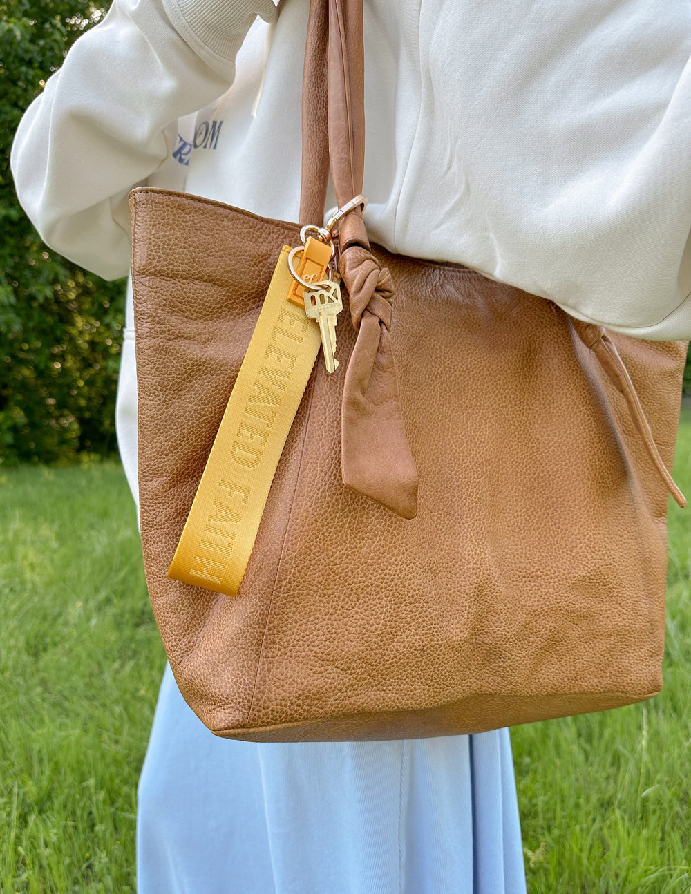 Elevated Faith Yellow Oversized Logo Keychain — lifestyle worn / used context