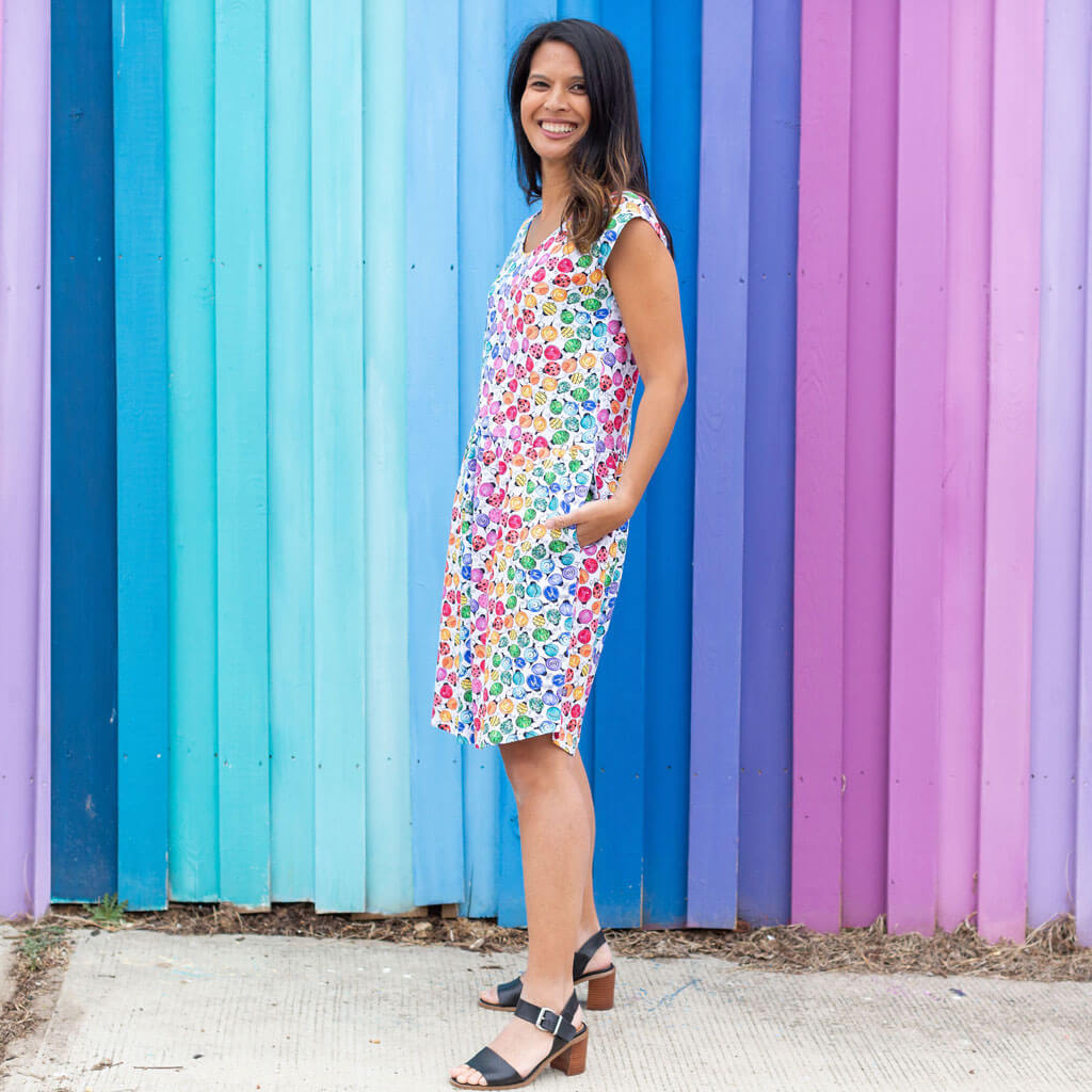 Princess Awesome & Boy Wonder Adult "Jewelbug" Rainbow of Bugs Cap Sleeve Dress with Pockets — Princess Awesome & Boy Wonder branding close-up