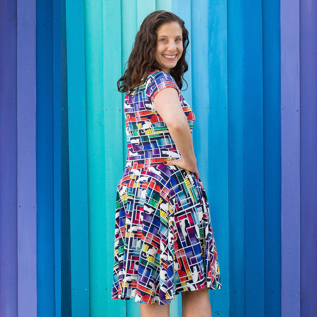Princess Awesome & Boy Wonder Adult "Check Meowt" Rainbow Books & Cats Super Twirler Dress with Pockets — Princess Awesome & Boy Wonder branding close-up