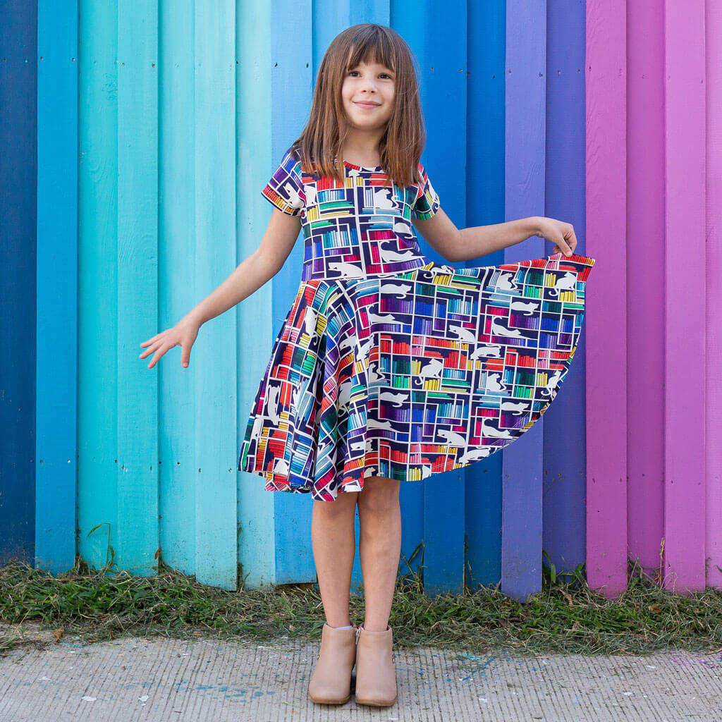Princess Awesome & Boy Wonder "Check Meowt" Rainbow Books & Cats Super Twirler Dress with Pockets — Princess Awesome & Boy Wonder branding close-up
