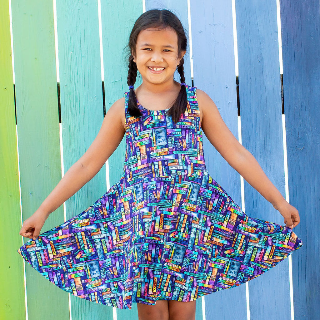 Princess Awesome & Boy Wonder "Lost in the Stacks" Books Sleeveless Play Dress with Pockets — Princess Awesome & Boy Wonder branding close-up