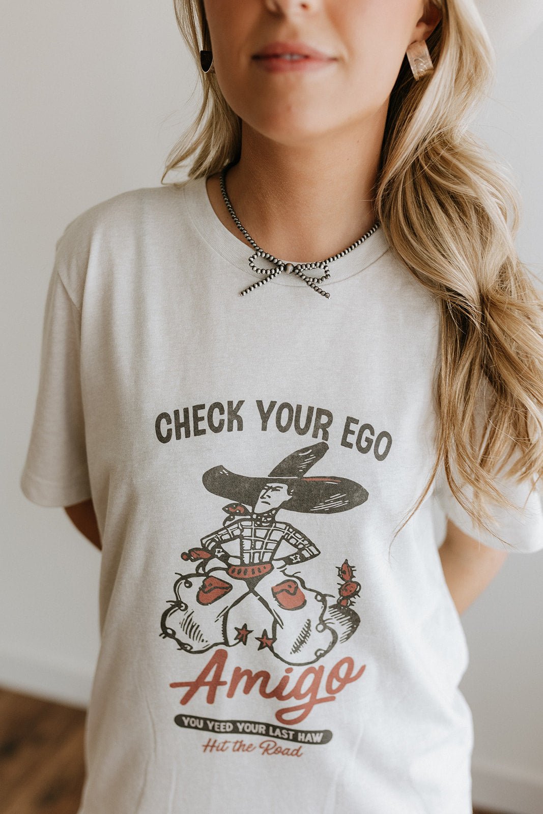 Wild Junkie Check Your Ego Amigo Cowboy Graphic Tee — detail close-up