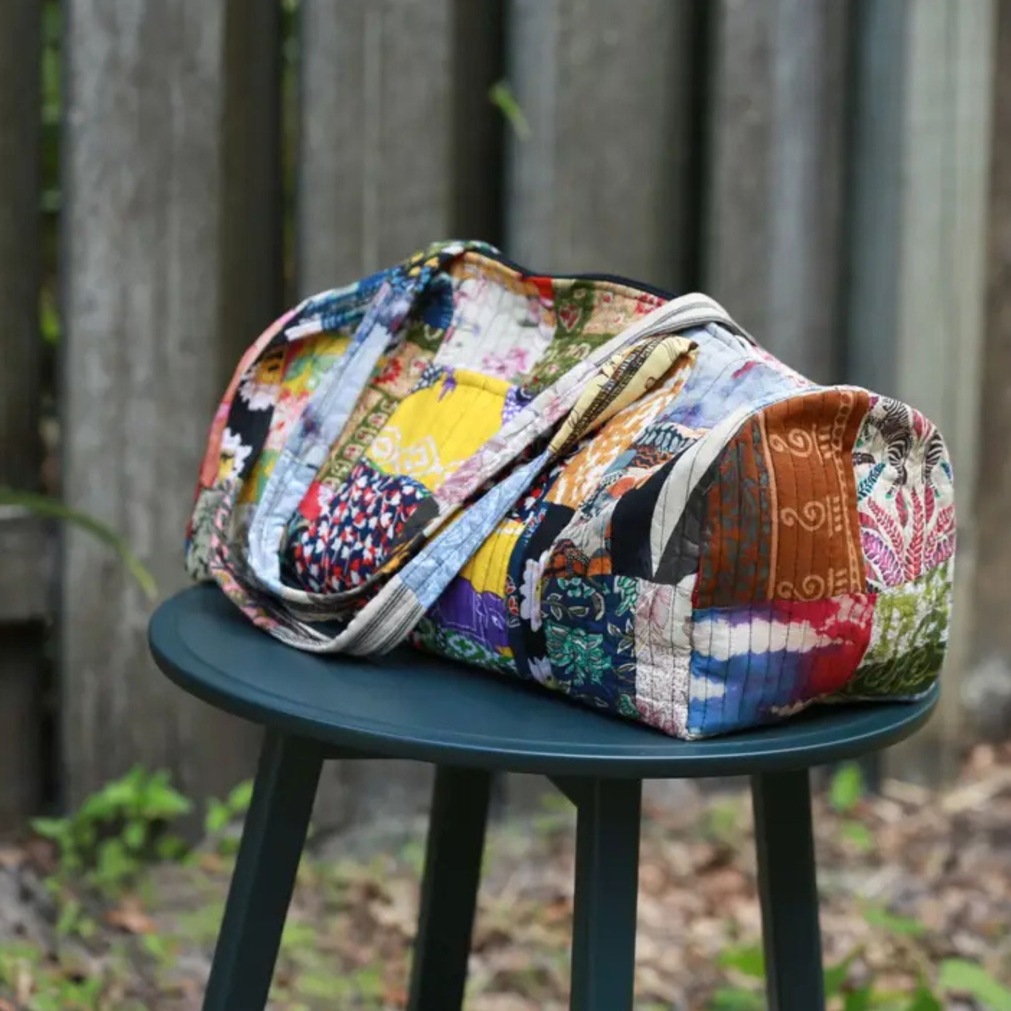 Darn Good Yarn Patchwork Quilted Duffle Bag — Darn Good Yarn branding close-up