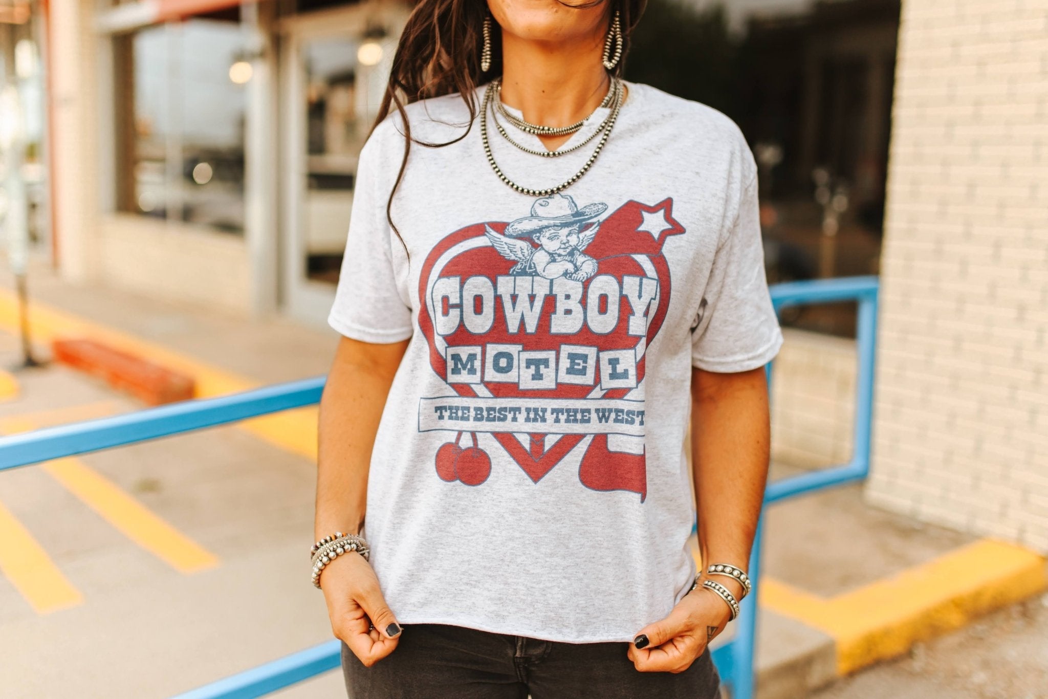 Wild Junkie Cowboy Motel Raw Cut V-neck Graphic Tee — back view
