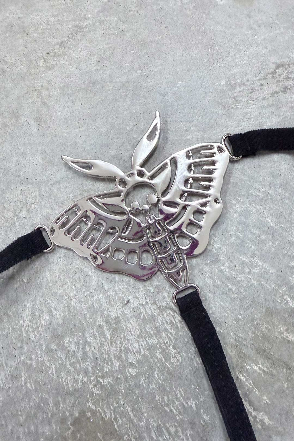 Thrash Happy Death Moth Metal Thong — detail close-up