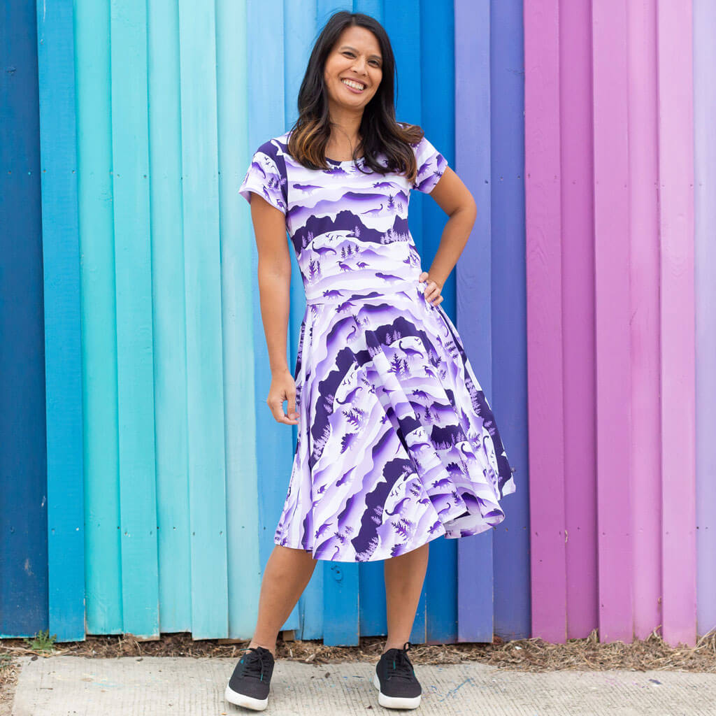 Princess Awesome & Boy Wonder Adult "Dinoscape" Dinosaur Wilderness Super Twirler Dress with Pockets — Princess Awesome & Boy Wonder branding close-up