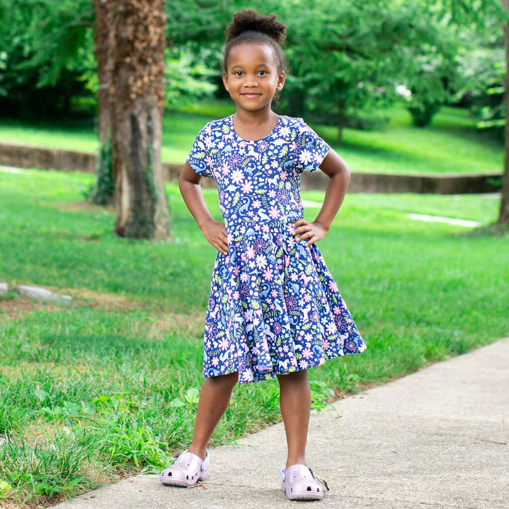 Princess Awesome & Boy Wonder "Only In My Dreams" Dinosaurs & Unicorns Super Twirler Dress with Pockets — Princess Awesome & Boy Wonder branding close-up
