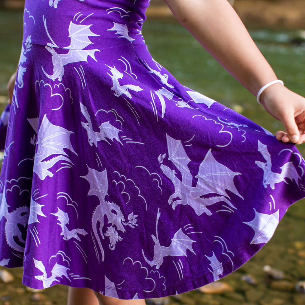 Princess Awesome & Boy Wonder "Purple Reign" Dragons Short Sleeve Super Twirler Play Dress with Pockets — Princess Awesome & Boy Wonder branding close-up