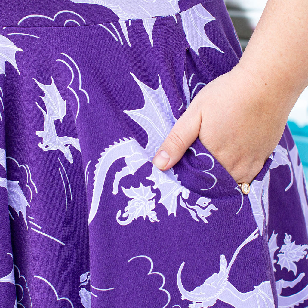 Princess Awesome & Boy Wonder Adult "Purple Reign" Dragons Short Sleeve Super Twirler Dress with Pockets — lifestyle worn / used context