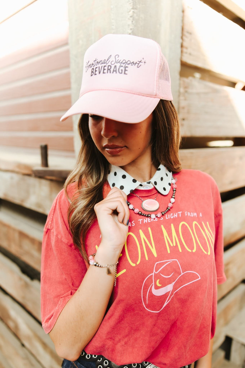 Wild Junkie Emotional Support Beverage Pink Trucker Hat — lifestyle worn / used context
