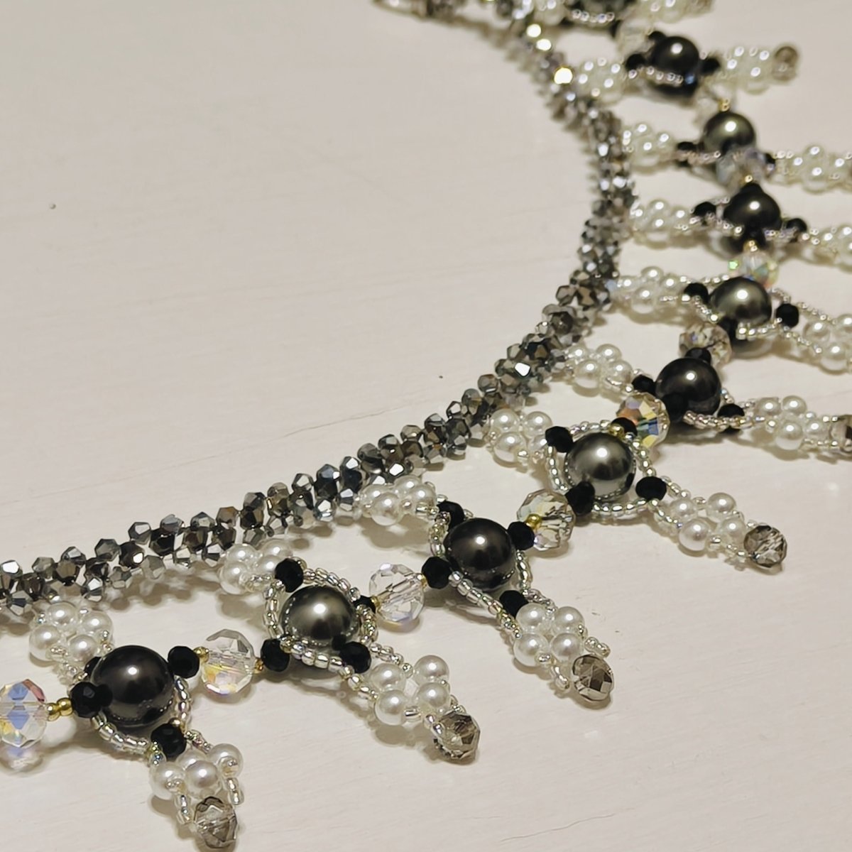 Mariam's Collection Handmade Woven Beaded Necklace | Glass Beads & Shell Pearls Choker | Intricate Seed Bead Art Necklace (MAC343) — Mariam's Collection branding close-up