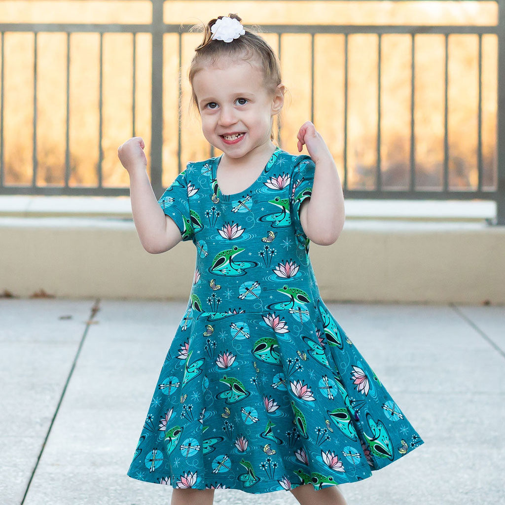 Princess Awesome & Boy Wonder Frogs Super Twirler Dress with Pockets — Princess Awesome & Boy Wonder branding close-up
