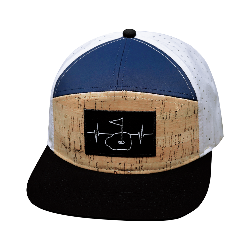 The Heartbeat Brand Golf Hat - Flat Bill - Cork - Black / Navy / White - Laser Mesh — lifestyle worn / used context