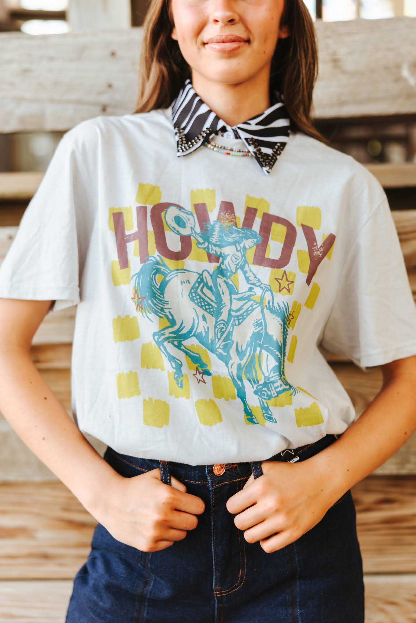 Wild Junkie Howdy Cowgirl Graphic Tee — Wild Junkie branding close-up