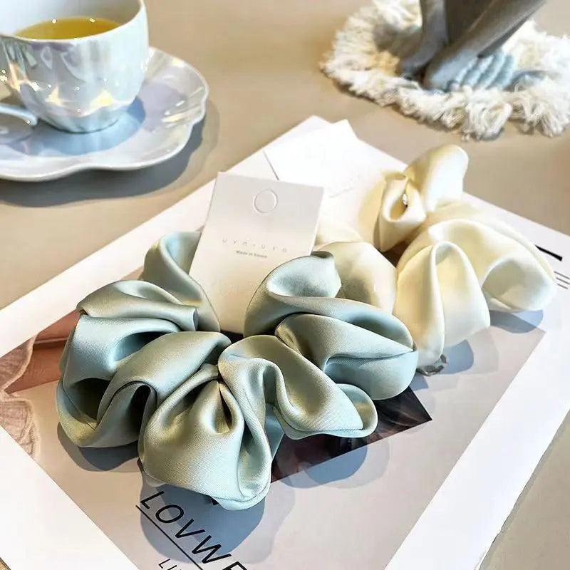 Mariam's Collection Mariam's Collection MAC011 hijab scrunchies，satin hair accessories — Mariam's Collection branding close-up