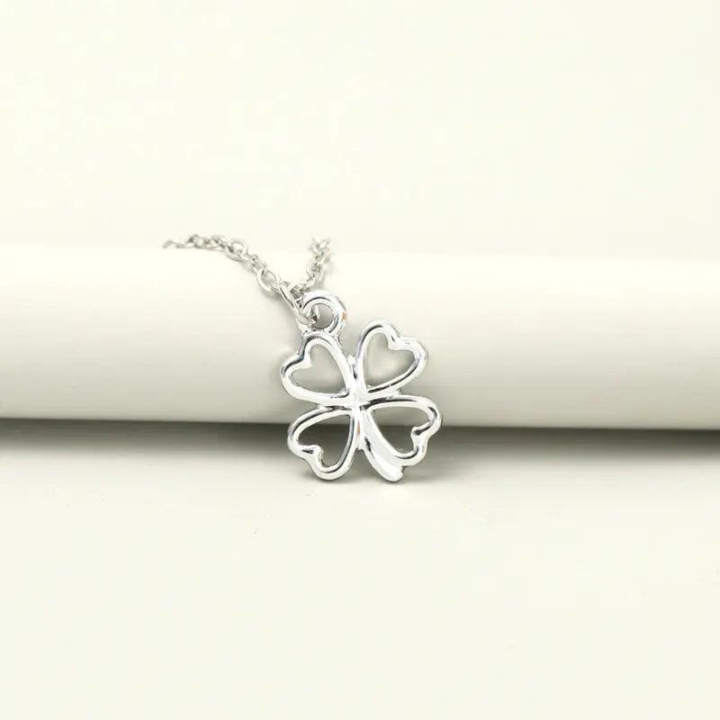Mariam's Collection MAC041 Platinum plated Four Leaf Clover Pendant Necklace — Mariam's Collection branding close-up