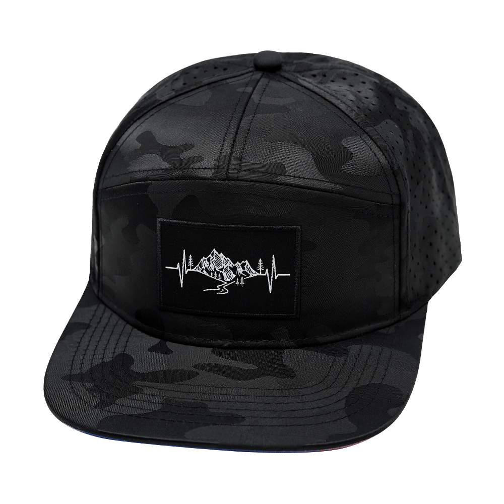 The Heartbeat Brand Mountains Hat - Flat Bill - Black Camo - Laser Mesh — lifestyle worn / used context
