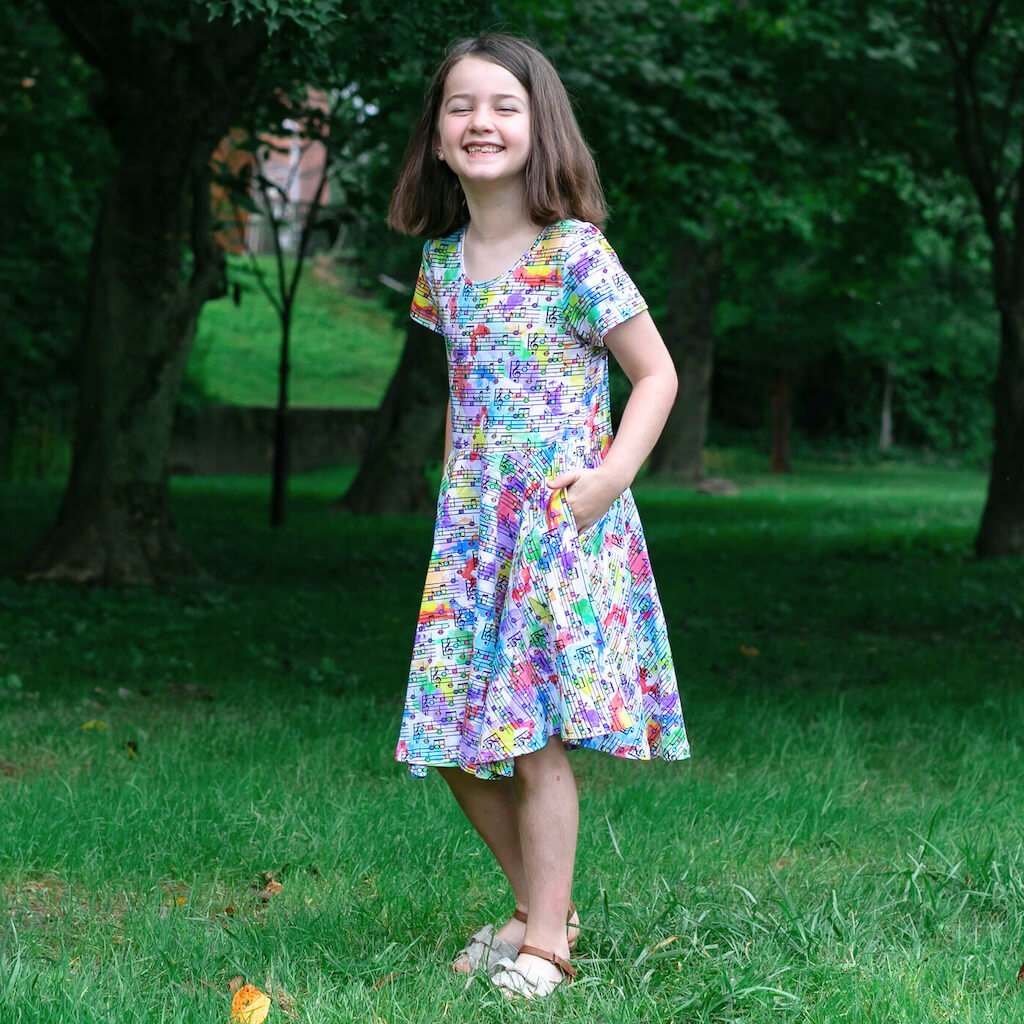 Princess Awesome & Boy Wonder "Staff Meeting" Rainbow Music Notes Super Twirler Dress with Pockets — side view