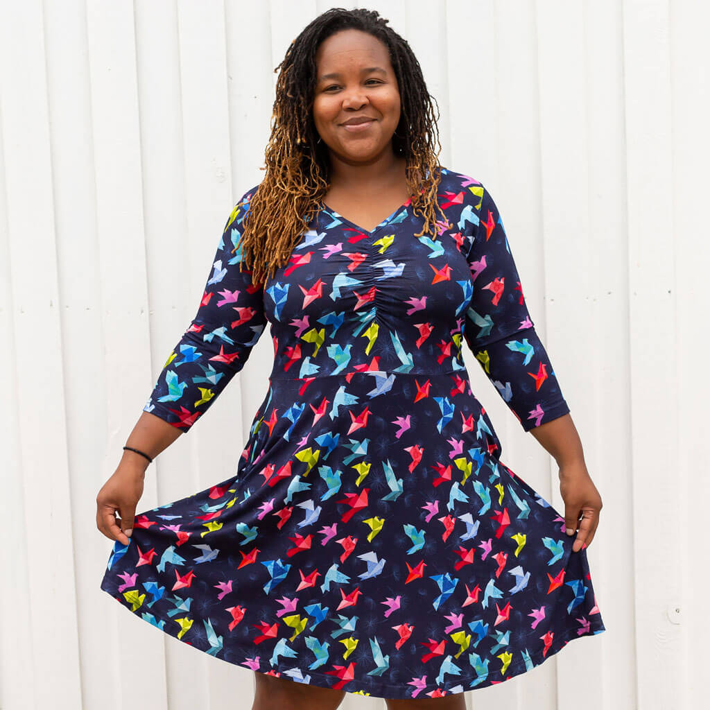 Princess Awesome & Boy Wonder Adult "Flight of Fancy" Origami Birds V-Neck A-Line Dress with Sleeves and Pockets — lifestyle worn / used context