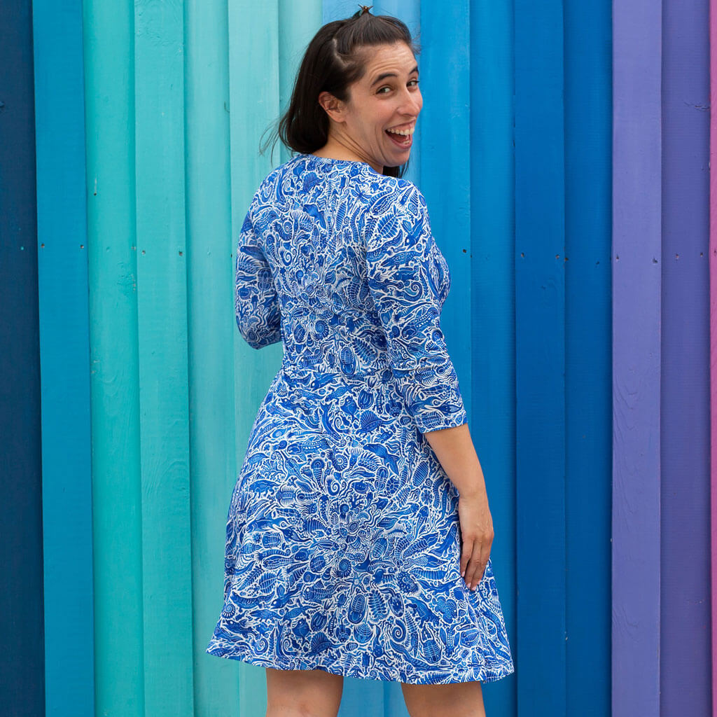 Princess Awesome & Boy Wonder Adult "Ancient Imprint" Paleo Paisley V-Neck A-Line Dress with Sleeves and Pockets — Princess Awesome & Boy Wonder branding close-up