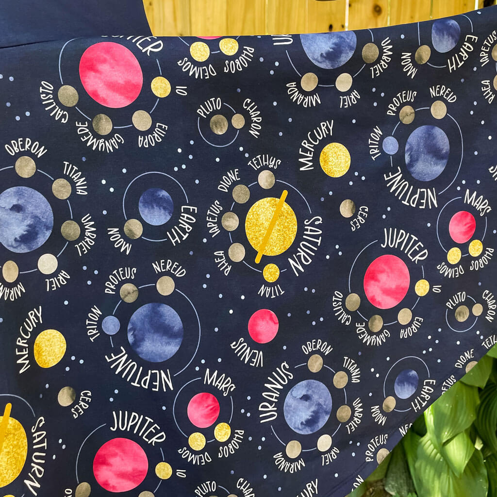 Princess Awesome & Boy Wonder "Night Lights" Planets and Moons Super Twirler Dress with Pockets — Princess Awesome & Boy Wonder branding close-up