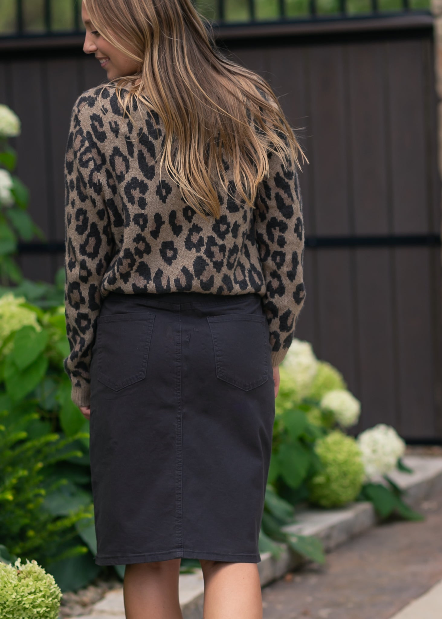 Inherit Co. Remi Onyx Black Denim Midi Skirt — in-use photo