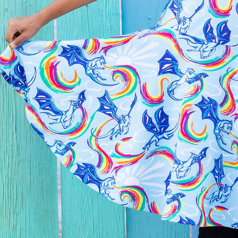 Princess Awesome & Boy Wonder Rainbow Breathing Dragons Super Twirler Dress with Pockets — Princess Awesome & Boy Wonder branding close-up