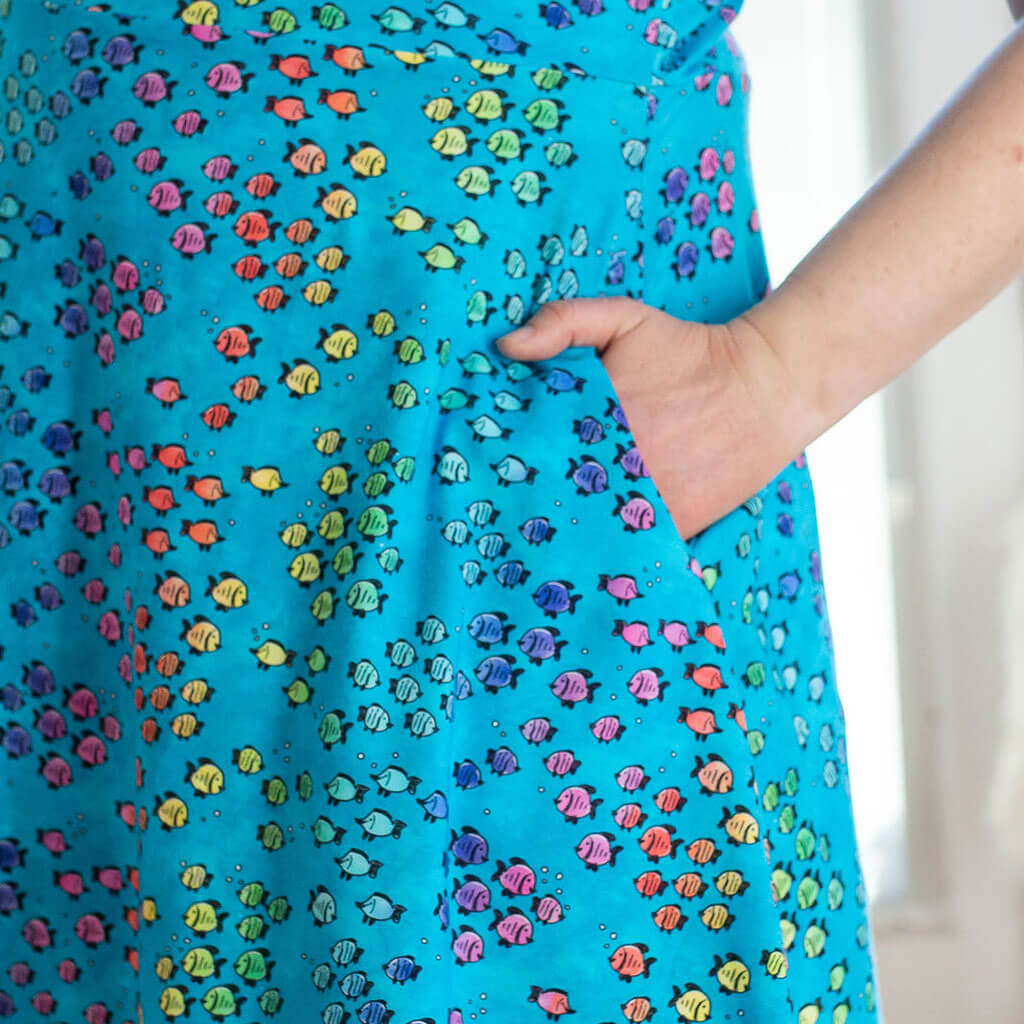 Princess Awesome & Boy Wonder Adult "Summer School" Rainbows of Fish Sleeveless Dress with Pockets — Princess Awesome & Boy Wonder branding close-up