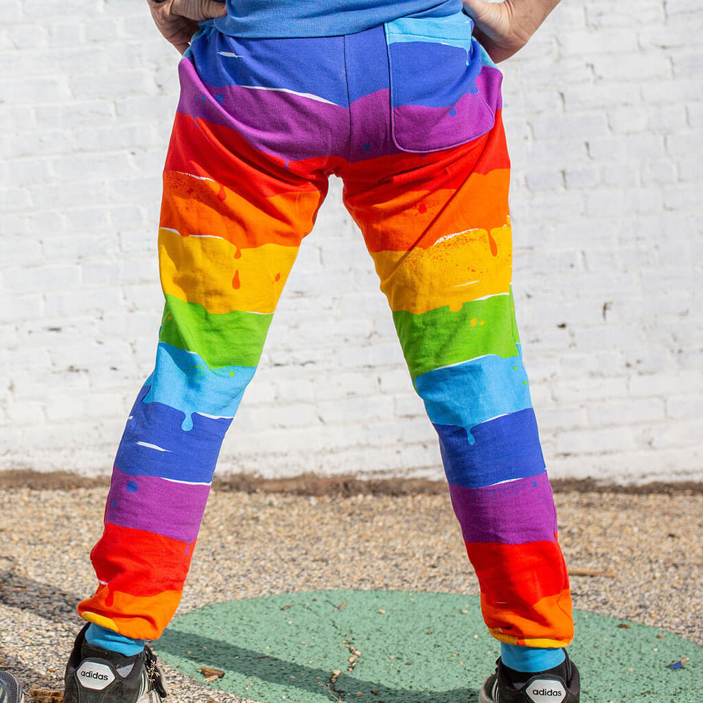 Princess Awesome & Boy Wonder Adult "Paint the Town" Rainbow Fuzzy Fleece Joggers with Pockets — Princess Awesome & Boy Wonder branding close-up