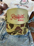 Wild Junkie Raisin' Hell Green Camo Trucker Hat — main product shot