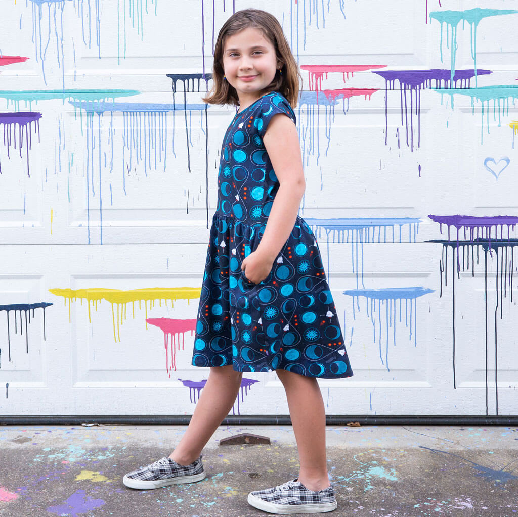 Princess Awesome & Boy Wonder "Gravity Assist" Rocket to the Moon Cap Sleeve Dress with Pockets — Princess Awesome & Boy Wonder branding close-up