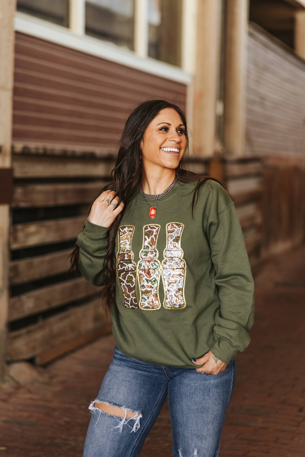 Wild Junkie Sequin Hunting Duck Calls Patch Sweatshirt — Wild Junkie branding close-up