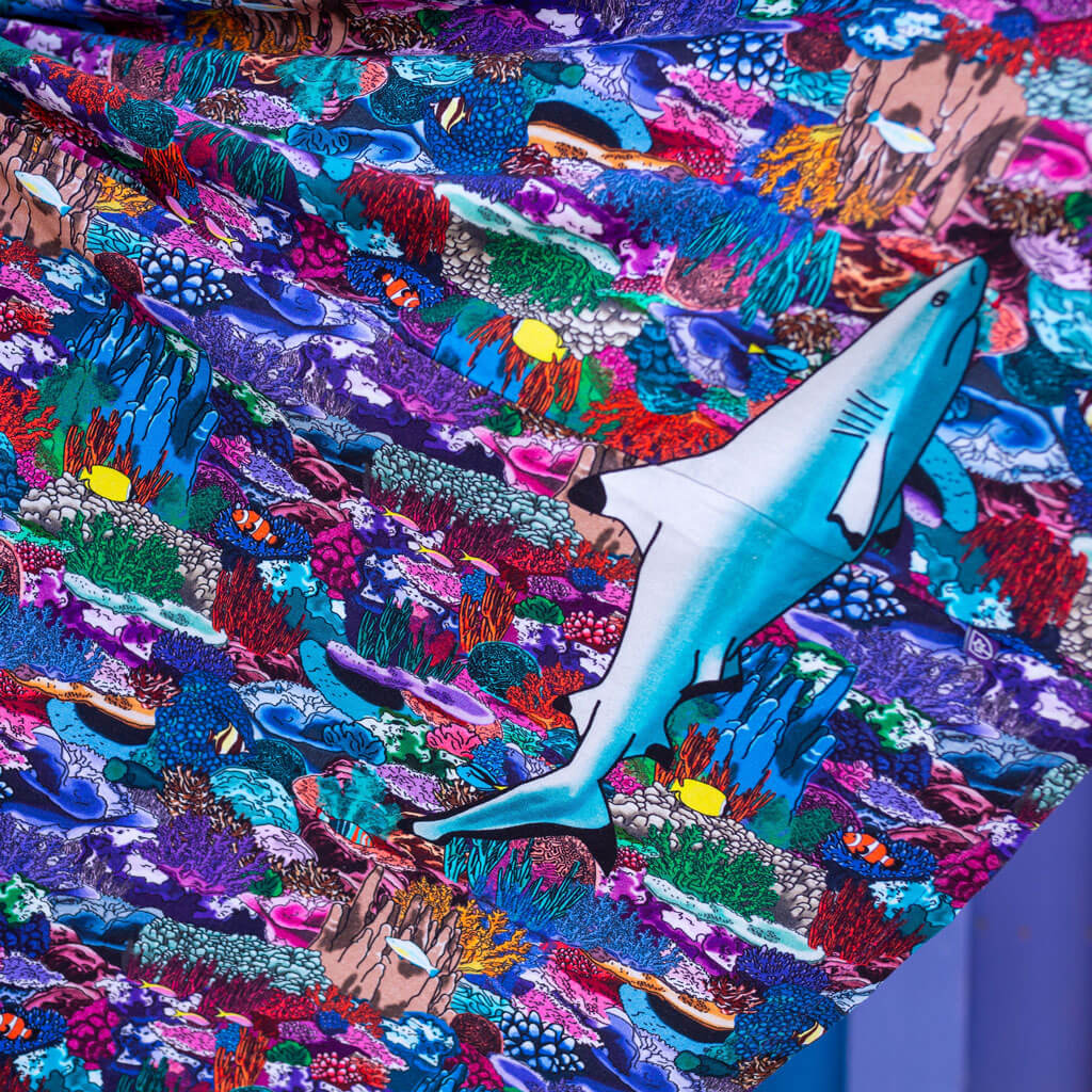 Princess Awesome & Boy Wonder "Chomping Grounds" Shark Reef Super Twirler Dress with Pockets — Princess Awesome & Boy Wonder branding close-up