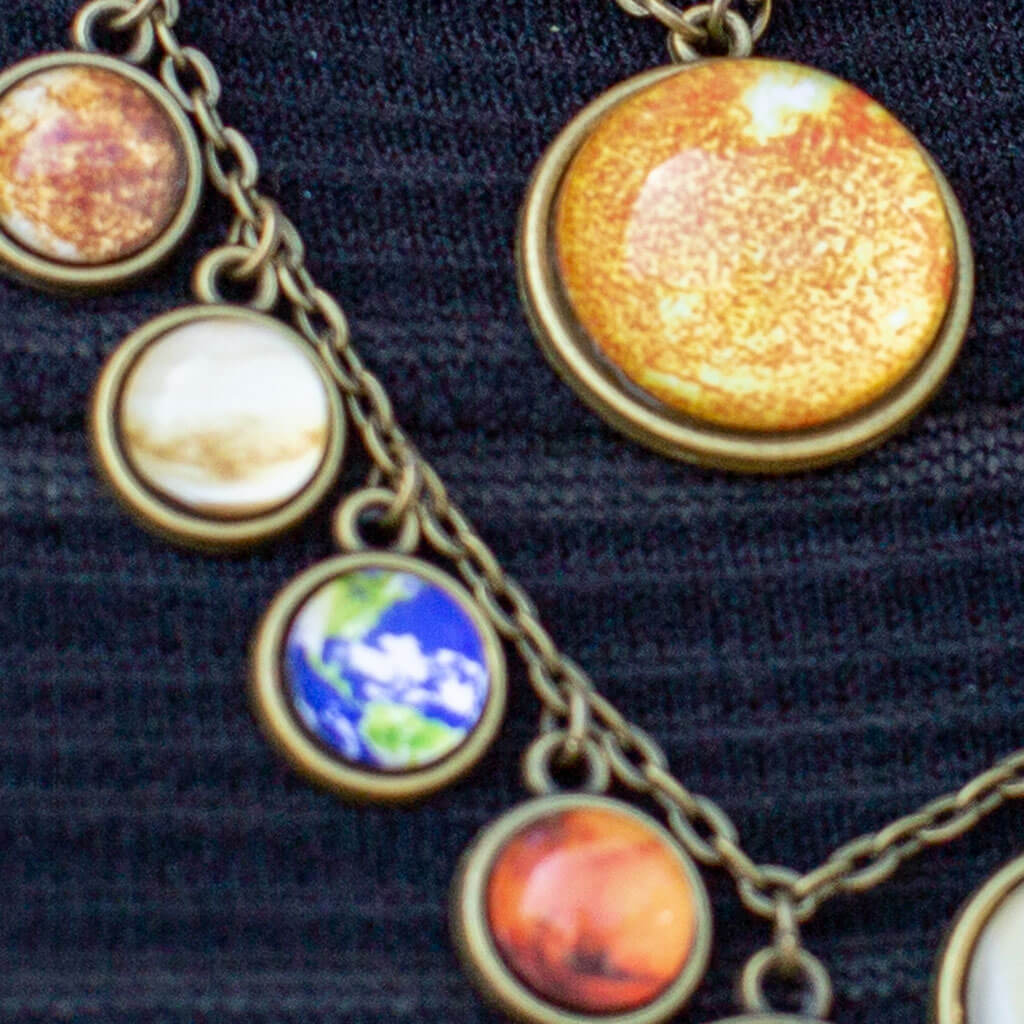 Princess Awesome & Boy Wonder Solar System Necklace — Princess Awesome & Boy Wonder branding close-up