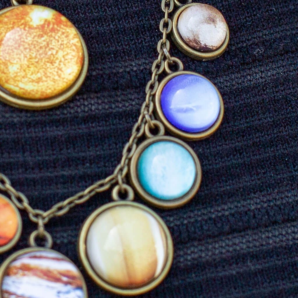 Princess Awesome & Boy Wonder Solar System Necklace — lifestyle worn / used context