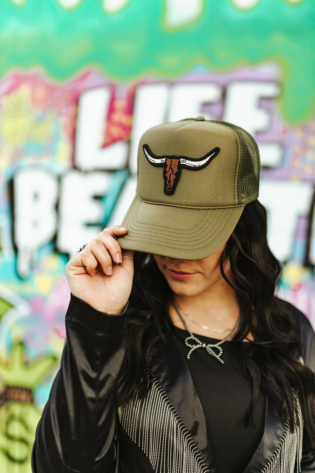 Wild Junkie Steer Skull Patch Trucker Hat — lifestyle context