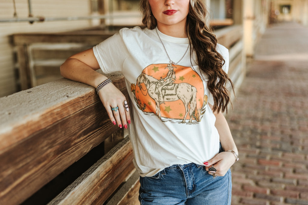 Wild Junkie Sunset Cowgirl Rider Graphic Tee — detail close-up
